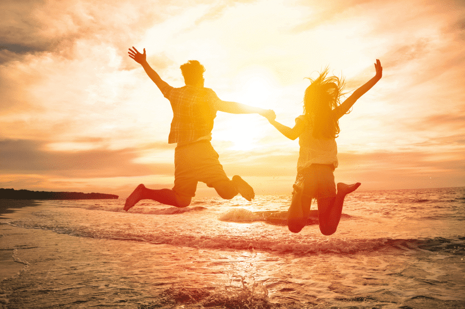Cute couple jumping at the beach flipped